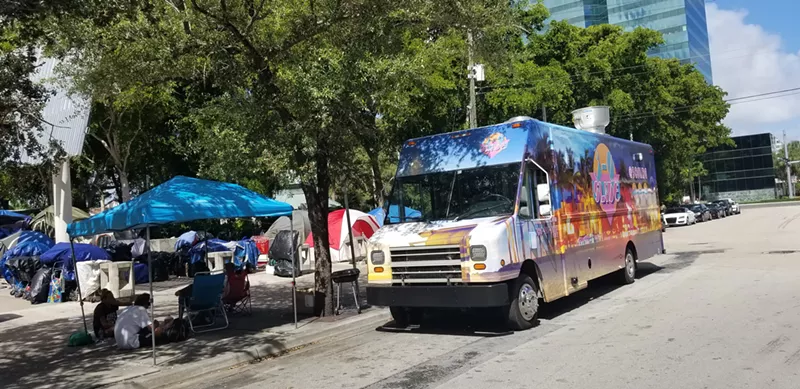 Image: The 3-0 Slide truck recently parked at the homeless camp near Fort Lauderdale's Main Library to feed more than 85 folks.