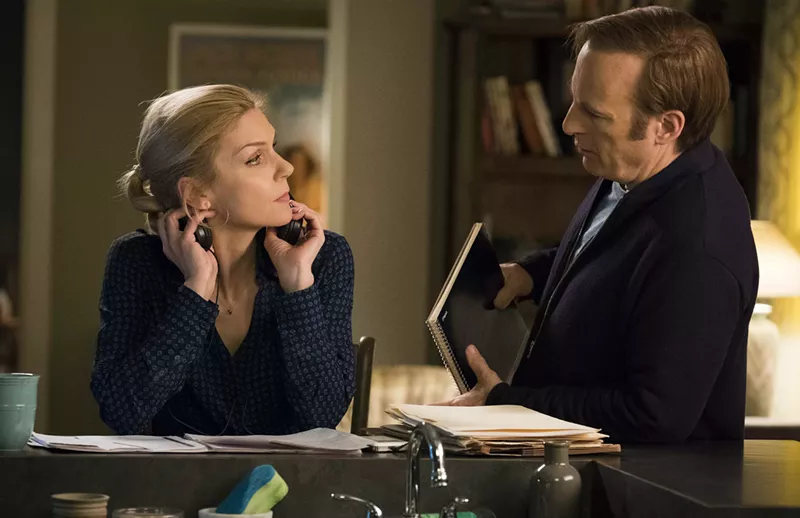 Image: Bob Odenkirk (right) plays Saul Goodman, née Jimmy McGill, a shyster/lawyer with a fake name who gets down to business with his lawyer girlfriend, Kim Wexler (Rhea Seehorn), in the AMC drama Better Call Saul.