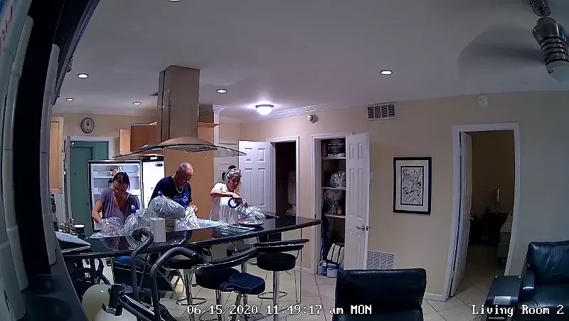 Image: Employees preparing an apartment for fumigation are seen not wearing masks or gloves while touching the tenant's belongings.