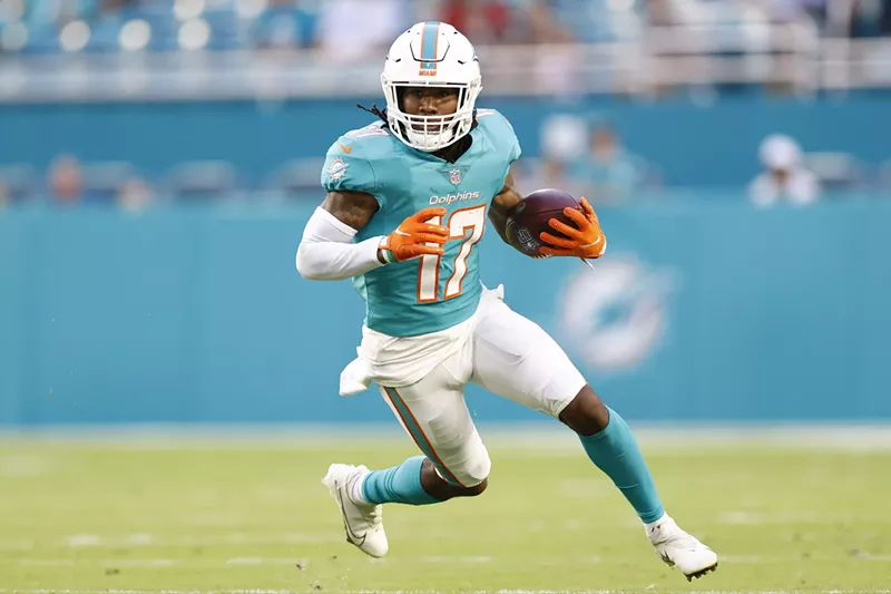 Image: Jaylen Waddle runs the ball during a preseason game against the Atlanta Falcons.