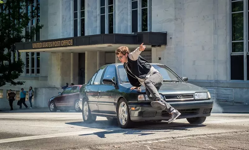 Image: Ansel Elgort, dancing with a car.