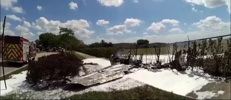 Image: The plane plummeted to the ground and collided with Bishop's SUV within earshot of a runway, outside an airport fence on SW 72nd Avenue.