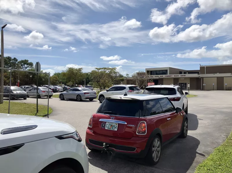 Image: Motorists wait in line for drive-thru coronavirus testing in Cutler Bay.