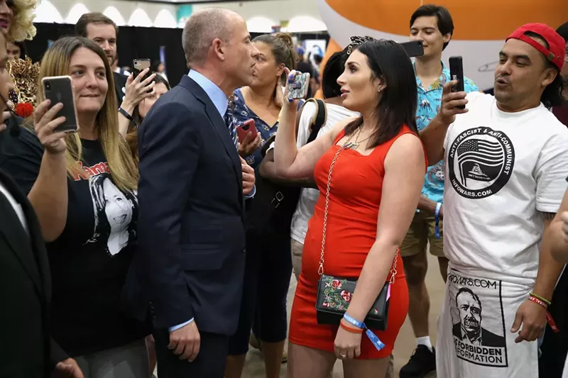 Image: Laura Loomer (right foreground) has a history of hateful rhetoric against Muslims and immigrants.
