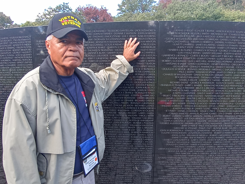 Image: Angel Rodriguez stands beside the Vietnam War Veterans Memorial in Washington D.C.