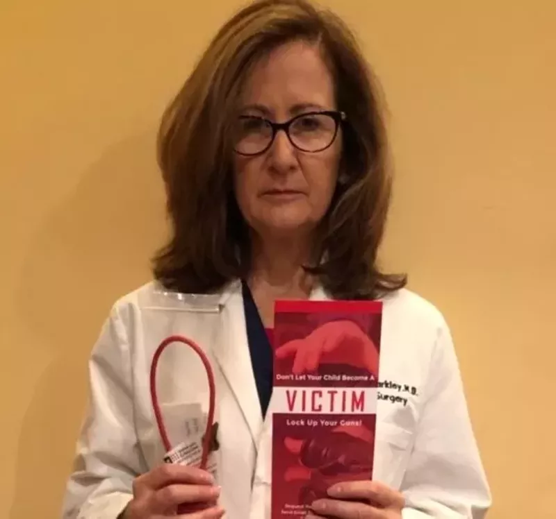 Image: A South Florida pediatric surgeon, Dr. Michele Markley poses with a Lock It Up! campaign brochure.