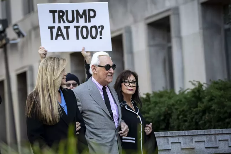 Image: Roger Stone walks with his wife Nydia Stone and his legal team as he arrives for the first day of his trial in Washington, D.C.