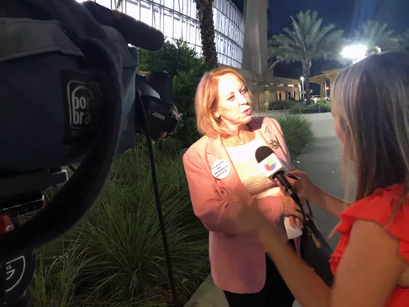 Image: Lourdes Diaz, of the League of Women Voters of Broward, speaks with reporters following Wednesday's commission meeting in Pembroke Pines.