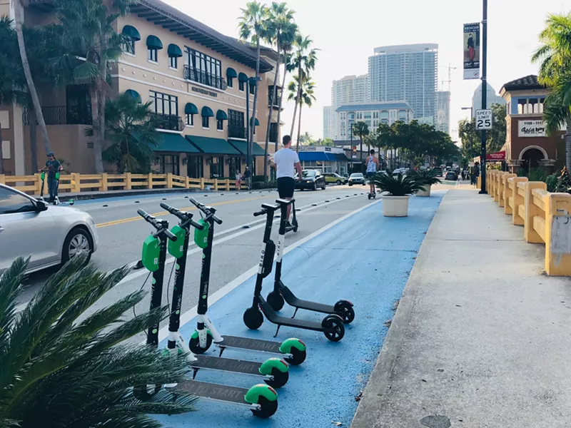 Image: Lime, Bird, and Bolt scooters are everywhere. Folks wearing helmets are not.