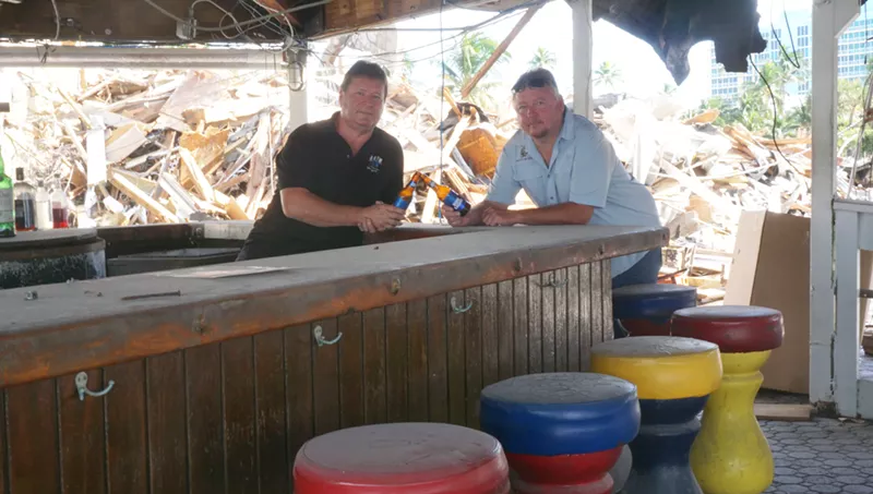 Image: From left: Jeff Hallick and Jeff Ryan share a final toast at Bahia Cabana's iconic tiki bar, which will be reduced to rubble by next week.