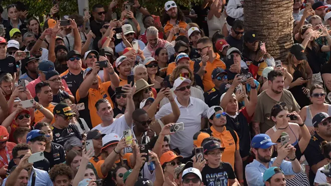 crowd shot. a lot of people holding up their phones to capture the podium ceremony