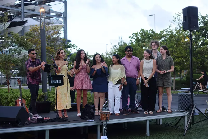 Image: Journalists lined up on an elevated outdoor stage
