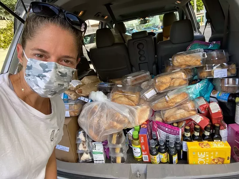 Image: Food Rescue US volunteer Rachel Unger with a Whole Foods Market haul.