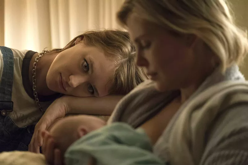 Image: In Tully, Mackenzie Davis (left) plays the title character, a boho caregiver in high-waisted jeans and crop top who becomes a supportive female friend to Marlo (Charlize Theron), an overextended working mom.
